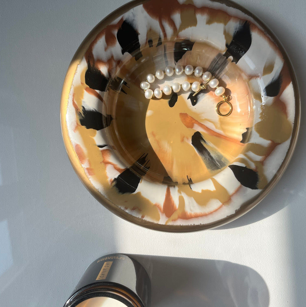 Vide-poche rond or et tacheté noir et terracotta